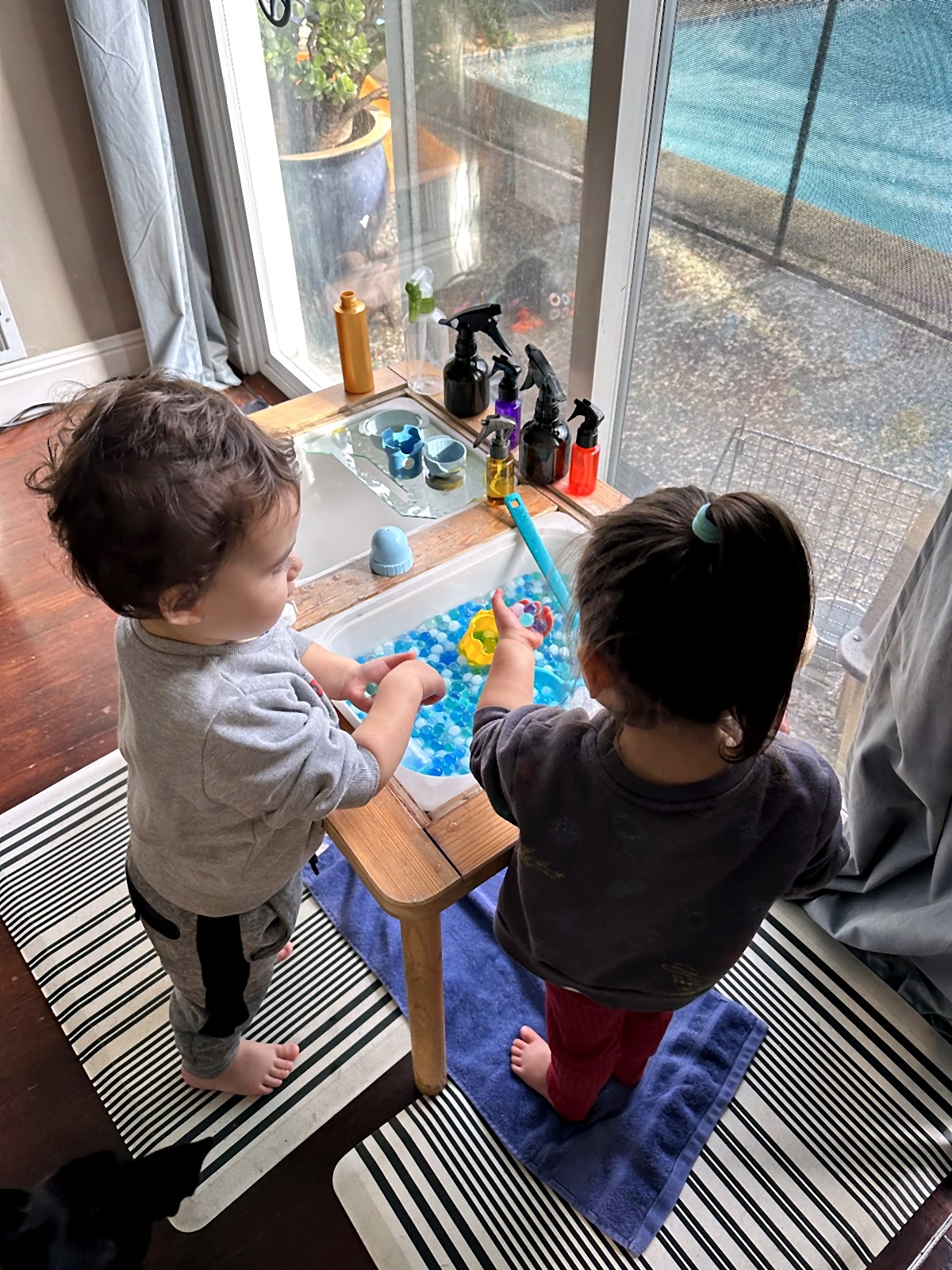Children exploring water beads in a sensory bin
