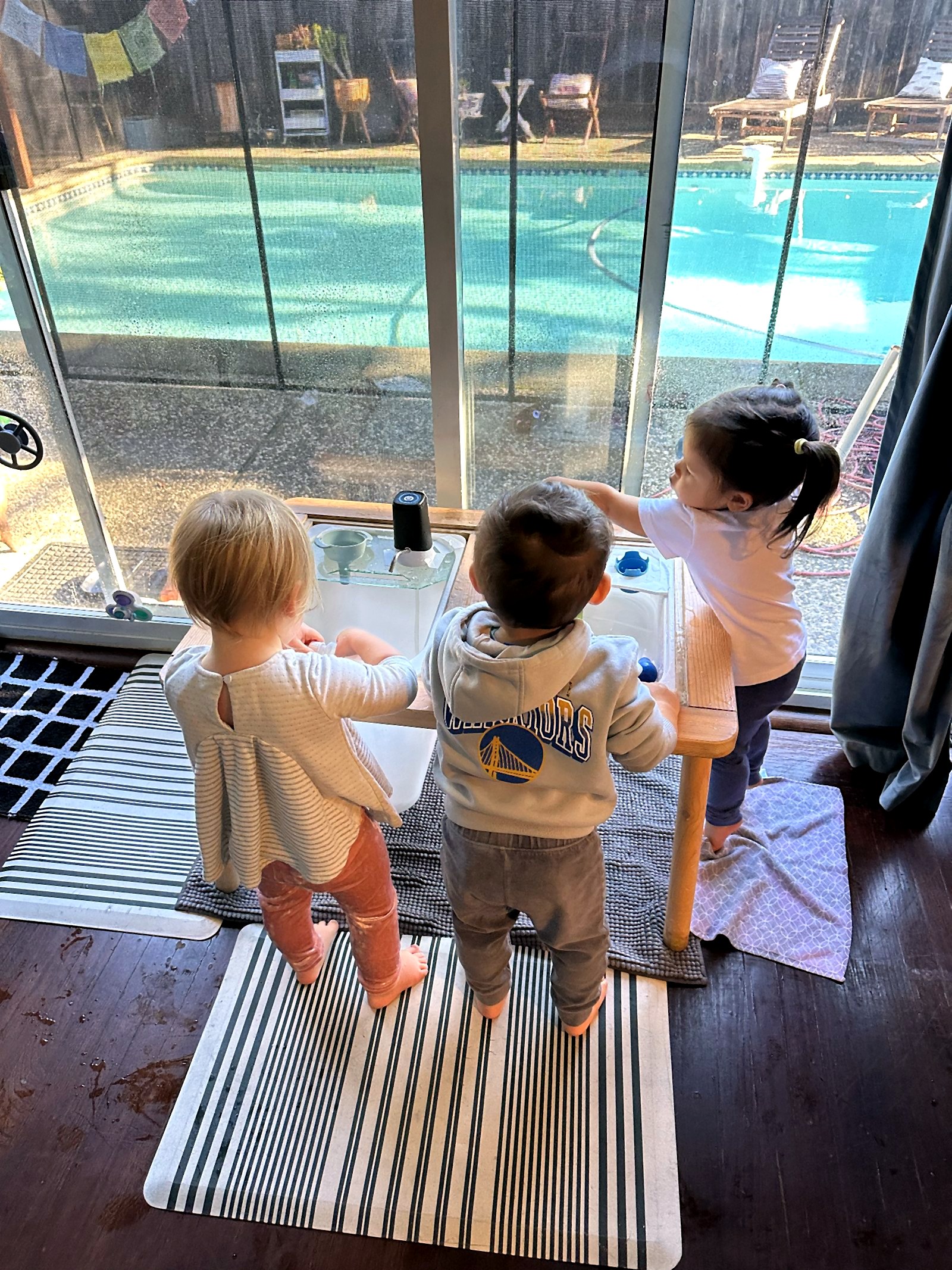 Children exploring together at the water table