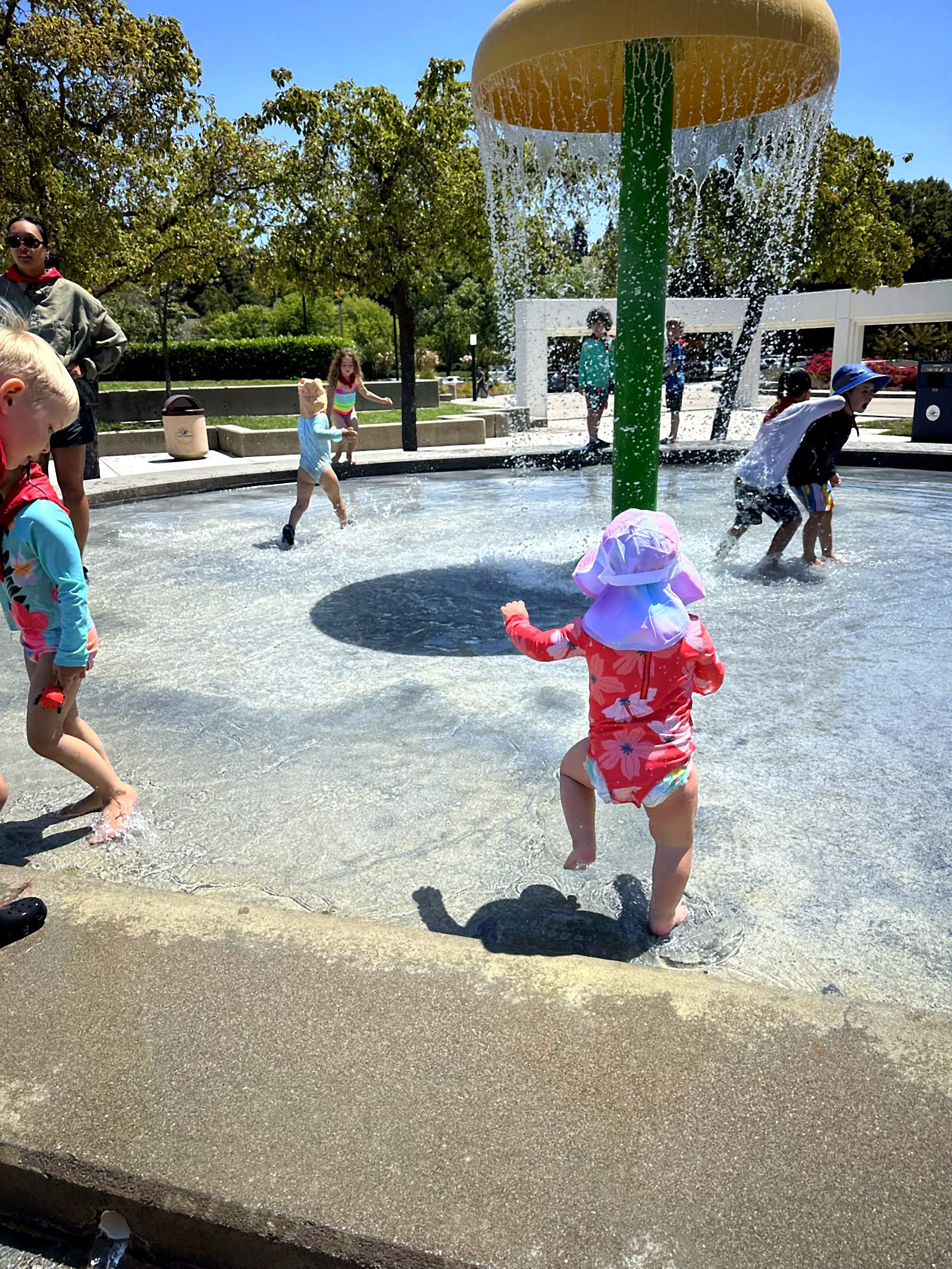 Children at the splash pad on a sunny outing
